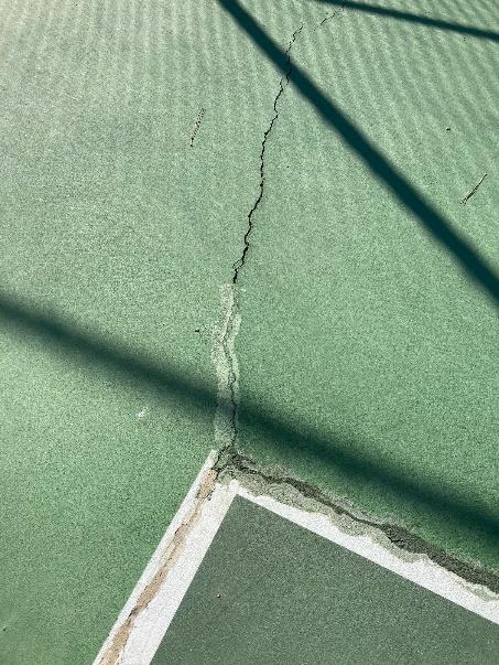Close-up of crack and surface delamination at court corner, Camino Real Park